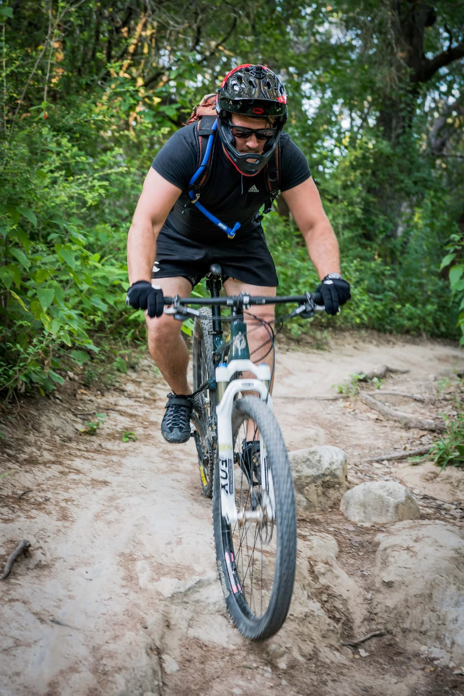 A mountain biker riding a rocky section of the Barton Creek greenbelt trail