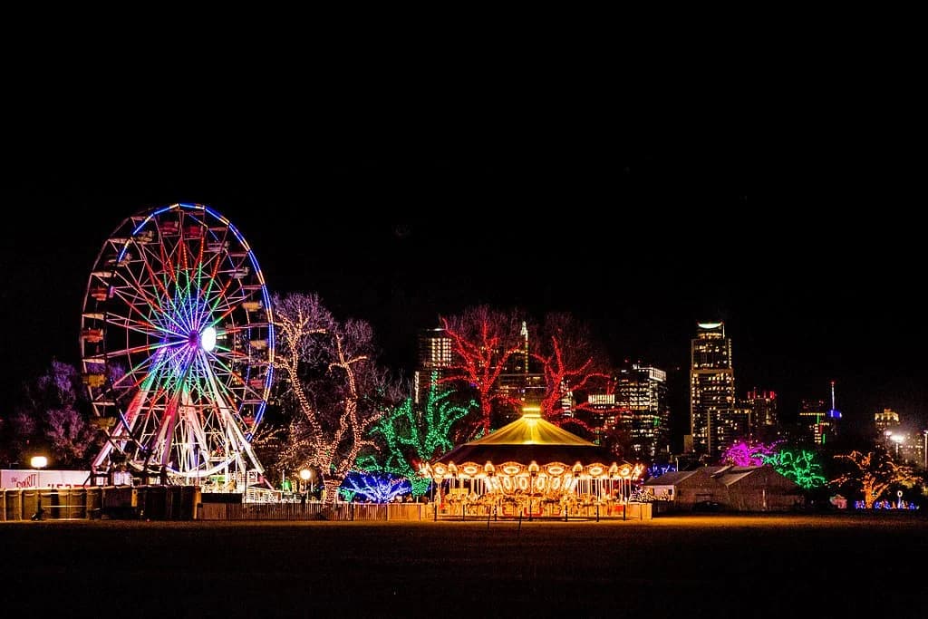 The Zilker Trail of Lights Ferris wheel and carousel glowing against the night skyline
