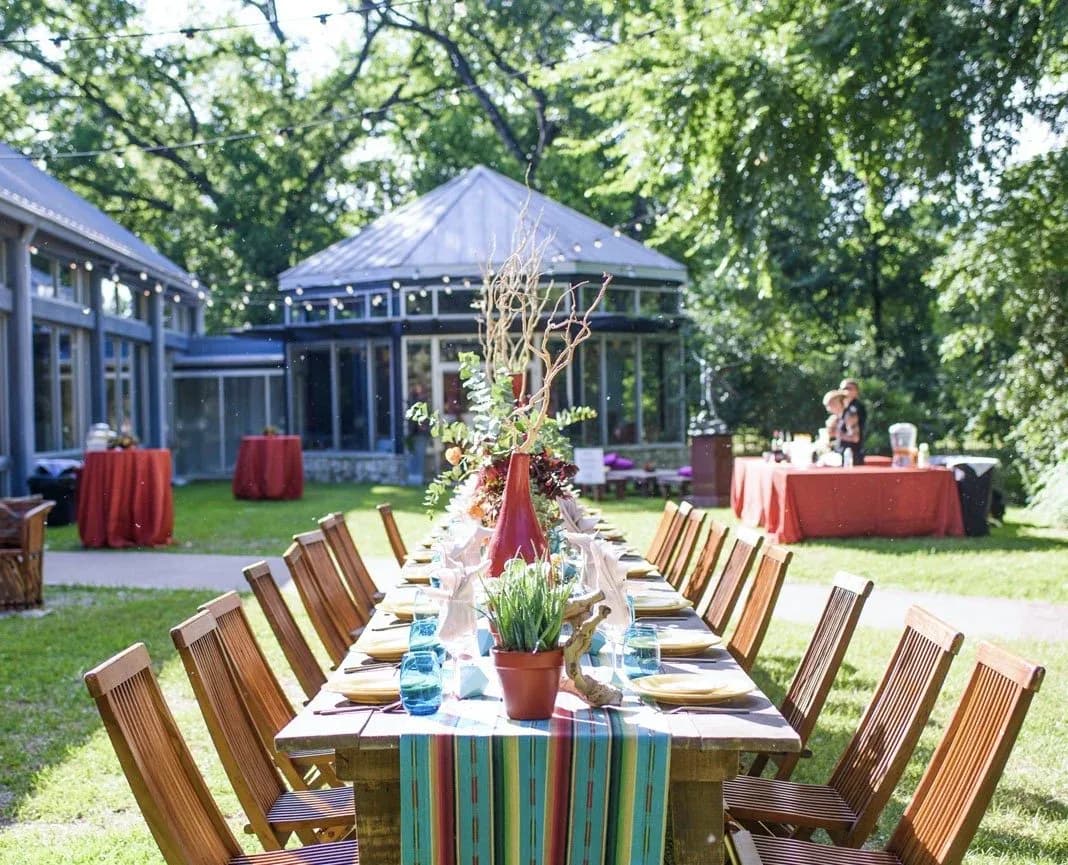 A banquet table set for an outdoor event on the grounds of a Zilker Park venue